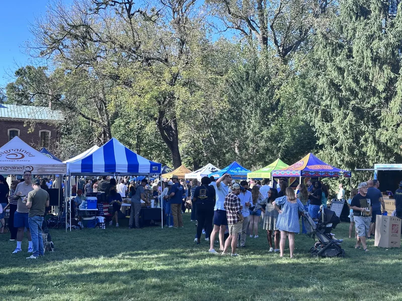 The crowd on the Great Lawn at Parktoberfest 2026 at Ashland, the Henry Clay Estate, with the brewery tents under the trees